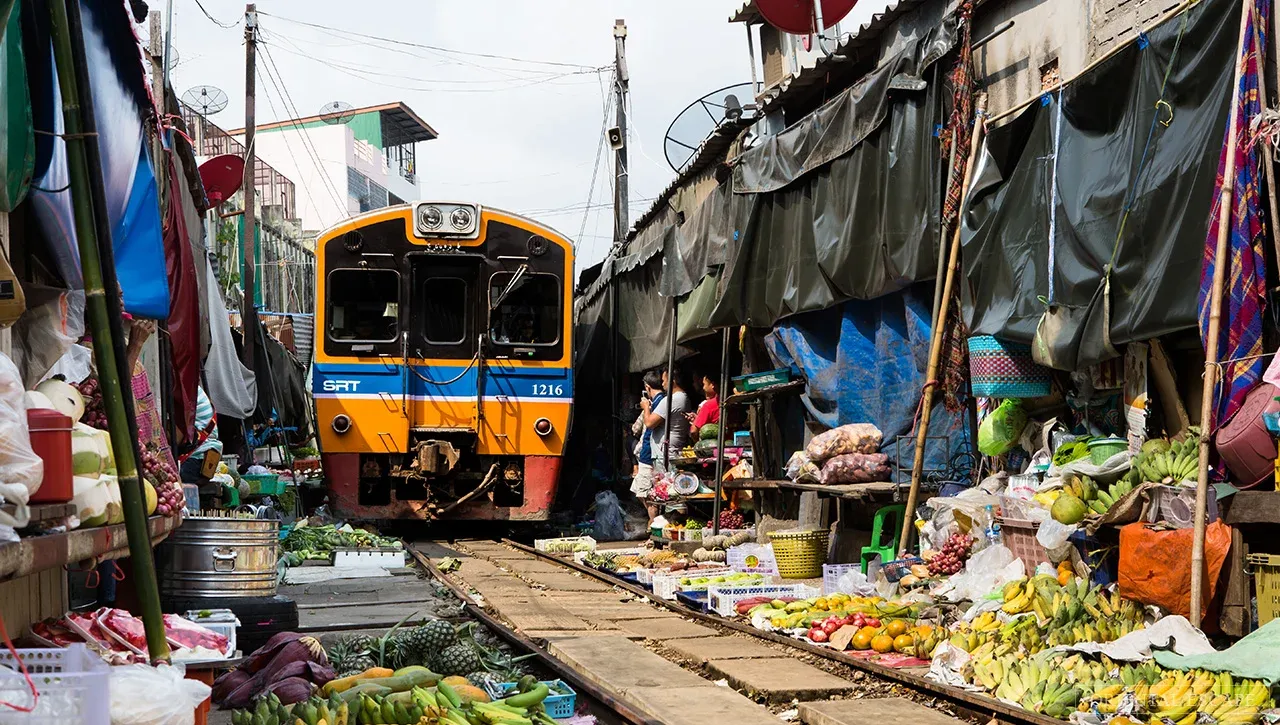 Bangkok Train Street (Maeklong Market) vs Hanoi Train Street: What Travelers Should Know